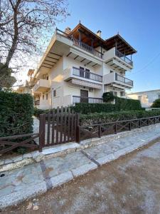 a building with a wooden fence in front of it at Luxury Apartment in Akrata