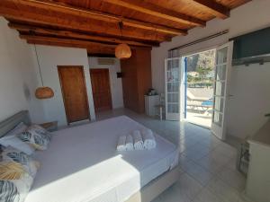 a bedroom with a bed with flip flops on it at Hotel Agia Roumeli by the SEA in Agia Roumeli