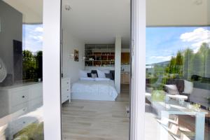 a bedroom with a bed and a large window at Apartament Na Bukowej - Wisła, widokowe studio in Wisła