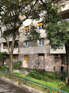 een appartementencomplex met bomen ervoor bij Domestico apartment in Rijeka