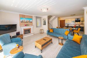 フェティエにあるVilla Yasam Park - Luxury 8 Person - Fethiye Calis Beach 90mtのリビングルーム(青いソファ、暖炉付)