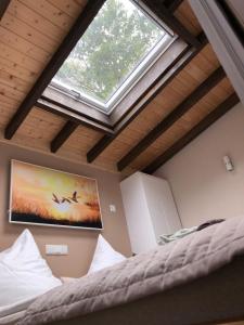 a bedroom with a large window in a room with a bed at HeiDeluxe TinyHouse in Soltau