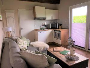 a living room with a couch and a table at HeiDeluxe TinyHouse in Soltau