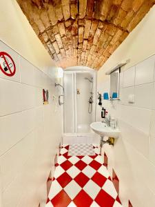 a bathroom with a red and white checkered floor at Express Guest House in Klaipėda
