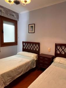 Posteľ alebo postele v izbe v ubytovaní Apartamento Edificio Cunchas
