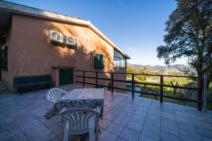 a patio with a table and chairs next to a building at Dimora Capoliveri in Capoliveri