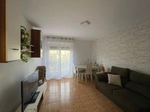 a living room with a couch and a table at Apartamento céntrico con vistas in Melilla