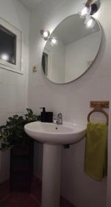 a bathroom with a white sink and a mirror at Apartamento céntrico con vistas in Melilla
