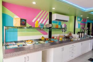 a kitchen with a counter with food on it at D8 Hotel Express in Fortaleza