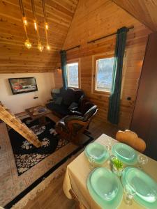 a living room with a table in a cabin at Cottage Mila in Žabljak
