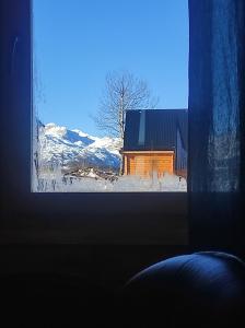 a window view of a barn in the snow at Cottage Mila in Žabljak