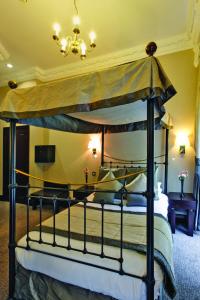 a bedroom with a bed and a canopy at Grange White Hall Hotel in London