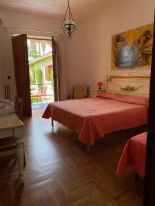 a bedroom with a bed with a red bedspread at Villa Giada in Tropea