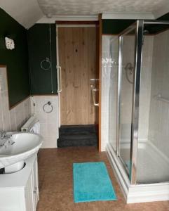 a bathroom with a shower and a sink and a toilet at York Cottage a period character 2 bedroom cottage in Snettisham