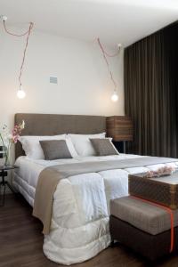 a bedroom with a large white bed and a couch at Hotel Unicorno in Florence
