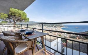 a balcony with a table and chairs and the ocean at Codolar Las mejores vistas en Tossa de Mar in Tossa de Mar