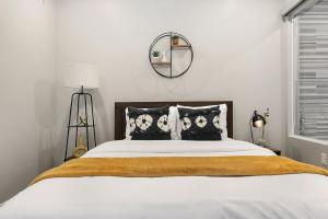 a bedroom with a large bed with a mirror on the wall at HostWise Stays - The Washington at Chatham - Free Garage Parking across from PPG Arena in Pittsburgh