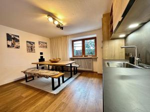 a kitchen with a table and a bench and a sink at Mountain Lodge Sölden - Ski in Bike out Chalet in Sölden