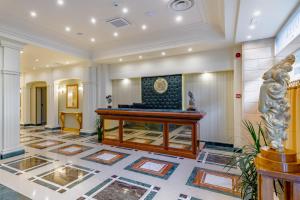 a lobby with a desk in the middle of a building at La Paloma Blanca Hotel in Sciacca