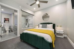 a bedroom with a green bed and a bathroom at HostWise Stays - The Washington at Chatham - Free Parking, Great Views, Across from PPG Arena in Pittsburgh