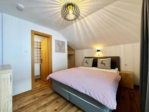 a bedroom with a large bed with a ceiling at Mountain Lodge Sölden - Ski in Bike out Chalet in Sölden