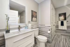a white bathroom with a toilet and a sink at HostWise Stays - The Washington at Chatham - Free Parking, Great Views, Across from PPG Arena in Pittsburgh