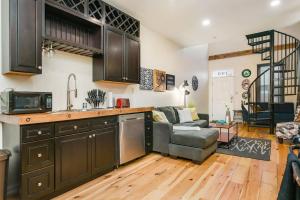 a kitchen and living room with a couch at HostWise Stays - The Ocala - Free Parking, Cool Space, Spiral Stairs in Pittsburgh