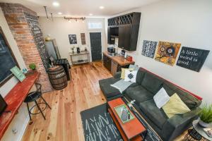 a living room with a couch and a table at HostWise Stays - The Ocala - Free Parking, Cool Space, Spiral Stairs in Pittsburgh