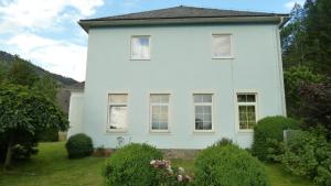 a white house with bushes in front of it at Lemmerer Homestay in Sankt Lorenzen bei Knittelfeld +11 photos