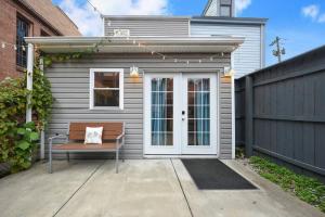 a bench sitting on a patio in front of a house at HostWise Stays - Chalk Art House - Chalkboard Wall, Private Parking, Patio in Pittsburgh