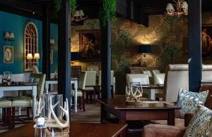 a restaurant with tables and chairs in a room at Blenkinsopp Castle Inn in Greenhead