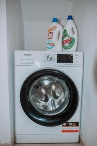 a washing machine with a detergent and a bottle of milk at Villa Sea Breeze in Karpathos