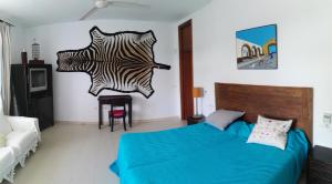 a bedroom with a bed and a zebra sculpture on the wall at Calle Anibal 37. in Chiclana de la Frontera