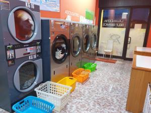 a row of washing machines in a laundry room at B&B Pittoresco in Specchia