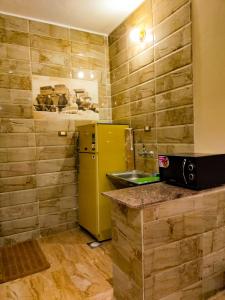 a kitchen with a yellow refrigerator and a sink at Safari Abu Simbel in Abu Simbel