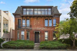 a brick house with a balcony on top of it at HostWise Stays - Grandview Balcony with Stunning Skyline Views in Pittsburgh