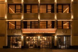 a view of the front of a building at night at Hôtel Dame des Arts in Paris