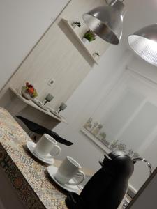 a kitchen with a table with cups and plates on it at Romántico estudio centro de Algeciras in Algeciras