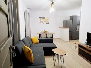 a living room with a couch and a table at Πλατανακι 2 Seaview Apartment in Andros
