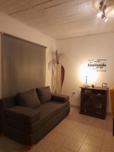 a living room with a couch and a table at Alojamiento Belén Catamarca - Planta Baja con Cochera Gratis in Belén