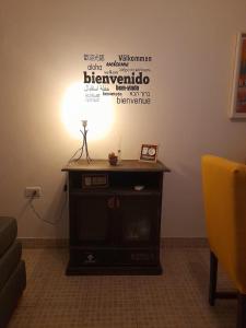 a table with a light on top of a room at Alojamiento Belén Catamarca - Planta Baja con Cochera Gratis in Belén