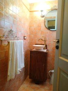 a bathroom with a sink and a mirror at Casina Rossa di Pietrafitta in Casarano