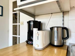two coffeemakers sitting on a counter in a kitchen at COC - Soleil Levant in Wissant