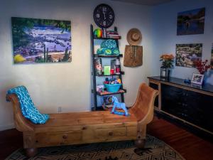 sala de estar con silla de madera y reloj en Birdwatch Cottage With River Beach Pass, en Three Rivers