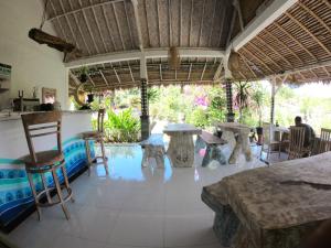 a dining room with tables and chairs in a house at Penida Hills in Nusa Penida