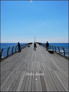 a group of people riding skateboards on a pier at Dolce Sosta in Ceriale