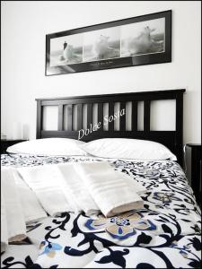 a bedroom with a bed with a black and white comforter at Dolce Sosta in Ceriale
