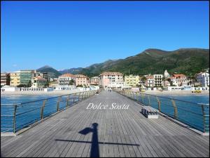 a shadow of a person standing on a pier at Dolce Sosta in Ceriale