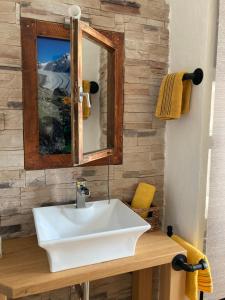 a bathroom with a white sink and a mirror at Ferienhaus Gruber in Aich