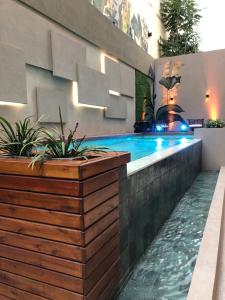 a swimming pool in the middle of a house at Usina Studio FMA-Coliving in Salta